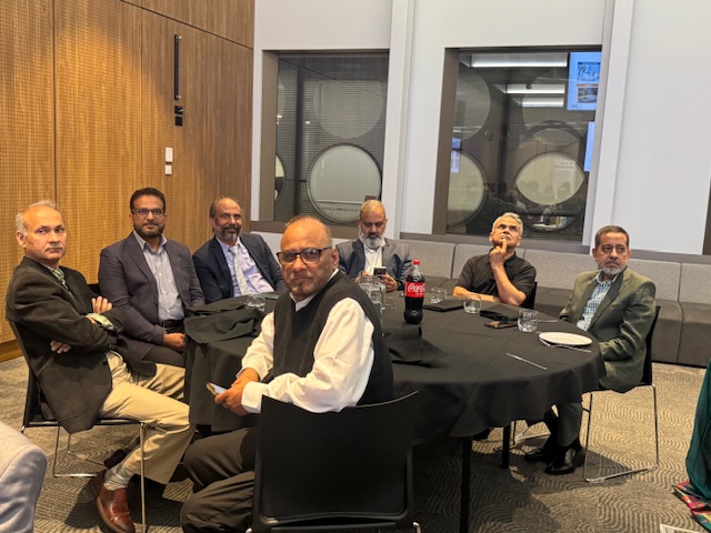 A group of men sitting around a round table

AI-generated content may be incorrect.