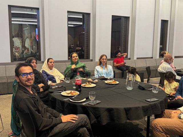 A group of people sitting around a round table

AI-generated content may be incorrect.