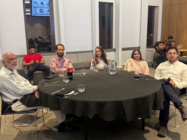 A group of people sitting around a round table

AI-generated content may be incorrect.