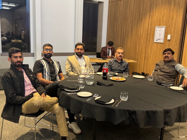 A group of men sitting at a round table

AI-generated content may be incorrect.