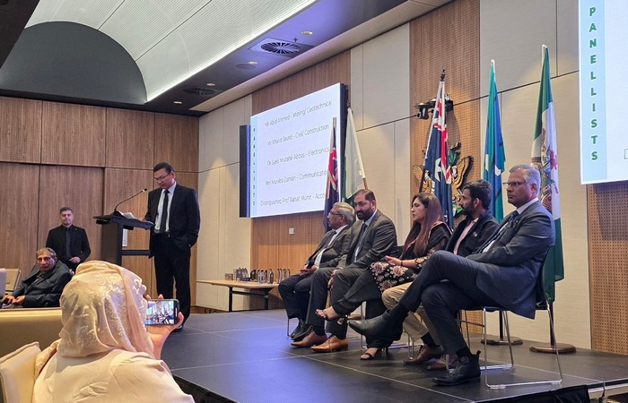 A person standing in front of a podium with a person in front of a group of people

AI-generated content may be incorrect.