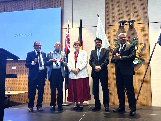 A group of people standing in front of a screen

AI-generated content may be incorrect.