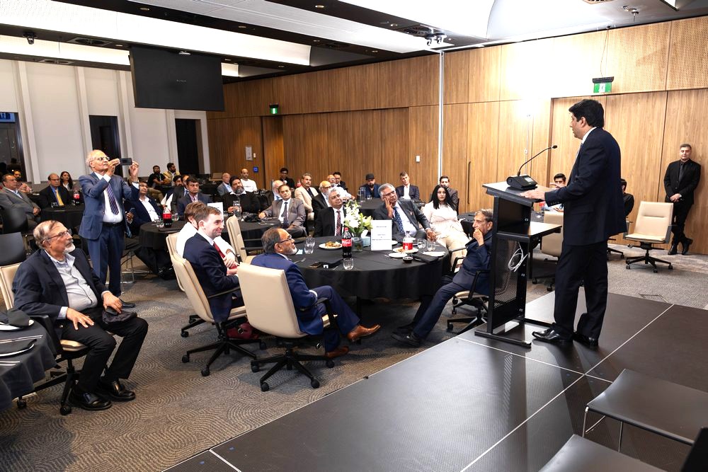 A person standing in front of a podium with a crowd of people in the background

AI-generated content may be incorrect.