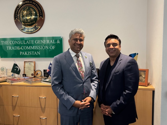 Two men standing in front of a desk

AI-generated content may be incorrect.