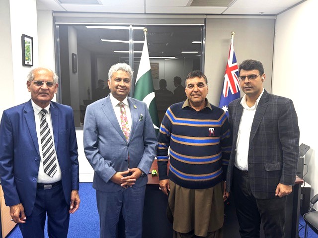 A group of men standing in front of a glass door

AI-generated content may be incorrect.