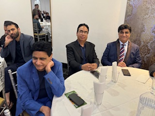 A group of men sitting at a round table

AI-generated content may be incorrect.