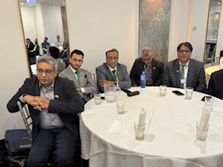 A group of men sitting at a round table

AI-generated content may be incorrect.