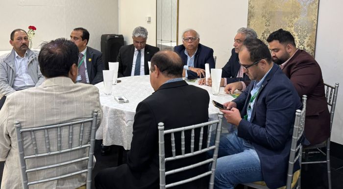 A group of men sitting at a round table

AI-generated content may be incorrect.