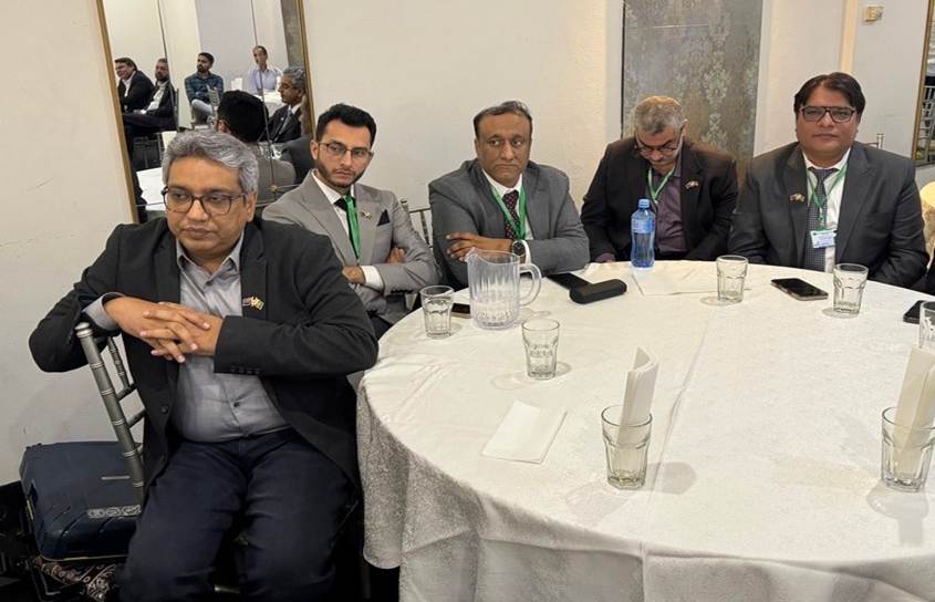A group of men sitting at a round table

AI-generated content may be incorrect.