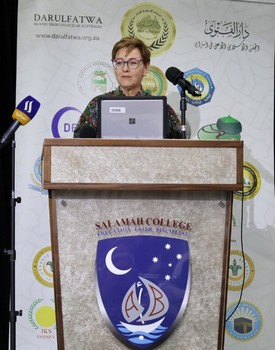 A person standing at a podium with microphones

AI-generated content may be incorrect.