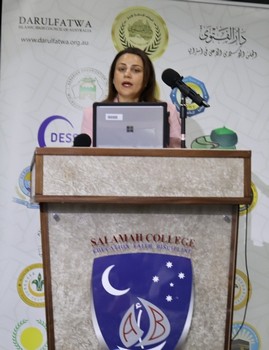 A person standing at a podium with microphones

AI-generated content may be incorrect.