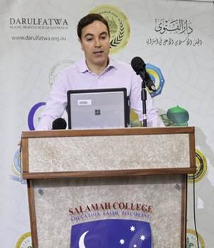 A person standing at a podium with microphones

AI-generated content may be incorrect.