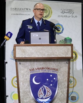 A person in a uniform standing at a podium

AI-generated content may be incorrect.