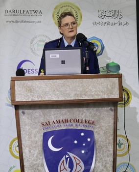 A person standing at a podium with microphones

AI-generated content may be incorrect.