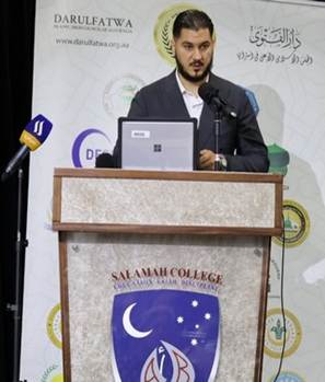 A person standing at a podium with microphones

AI-generated content may be incorrect.