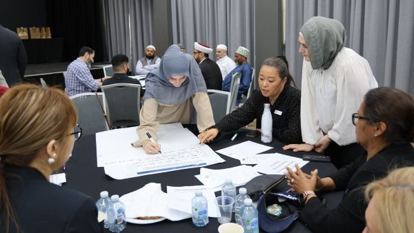 A group of people sitting around a table

AI-generated content may be incorrect.