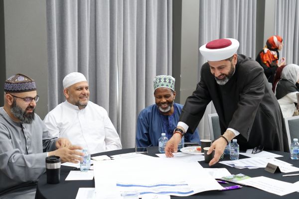 A group of people sitting around a table

AI-generated content may be incorrect.