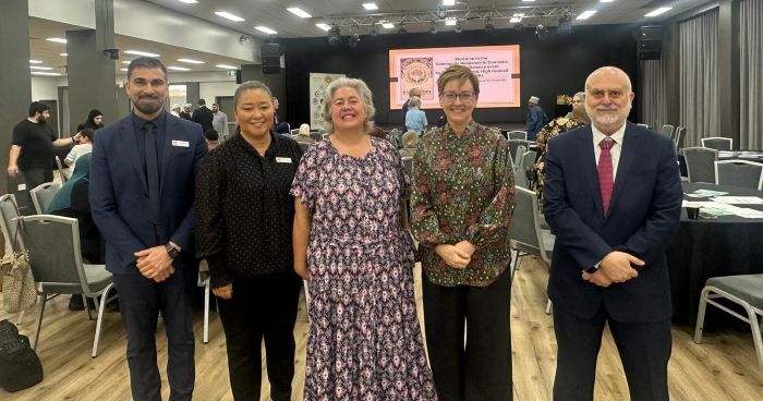 A group of people standing together

AI-generated content may be incorrect.