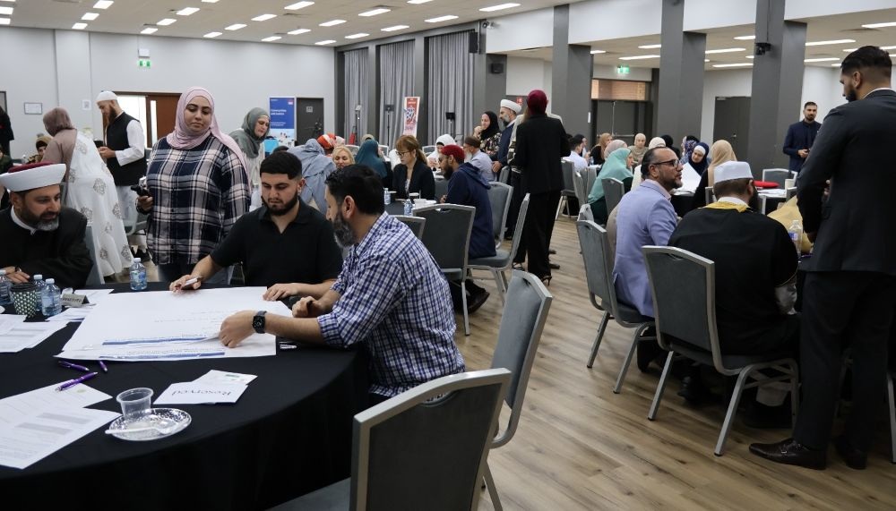 A group of people sitting at a table

AI-generated content may be incorrect.