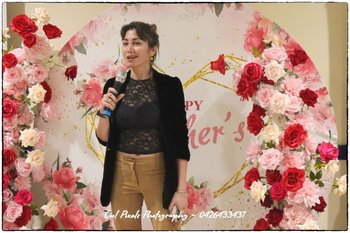 A person standing in front of a flower display

AI-generated content may be incorrect.