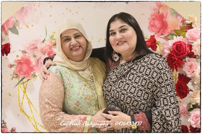 Two women posing for a picture

AI-generated content may be incorrect.