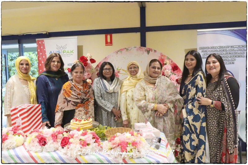 A group of women standing in front of a table with flowers

AI-generated content may be incorrect.