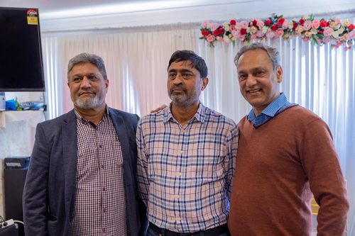 A group of men standing together

AI-generated content may be incorrect.