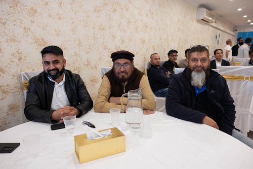 A group of men sitting at a table

AI-generated content may be incorrect.