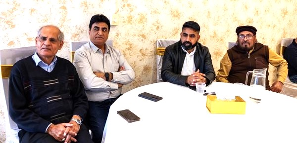 A group of men sitting at a table

AI-generated content may be incorrect.