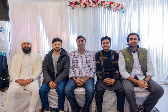 A group of men sitting on a couch

AI-generated content may be incorrect.