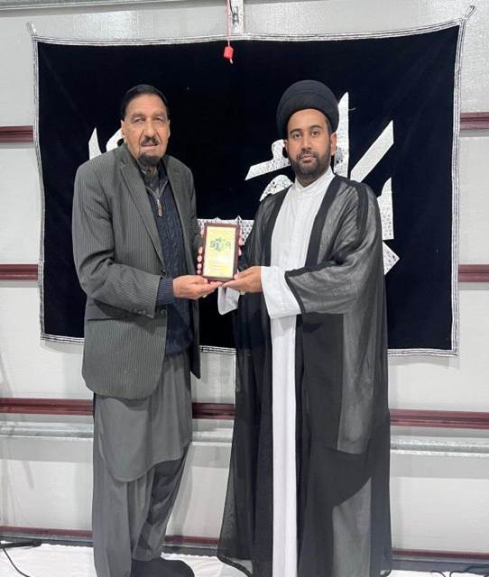 Two men standing in front of a flag

AI-generated content may be incorrect.