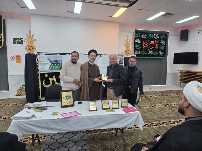 A group of men standing around a table with awards

AI-generated content may be incorrect.