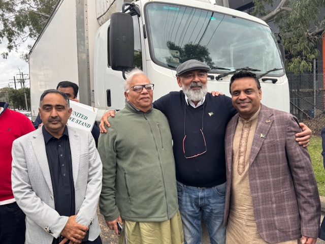 A group of men standing together in front of a truck

AI-generated content may be incorrect.
