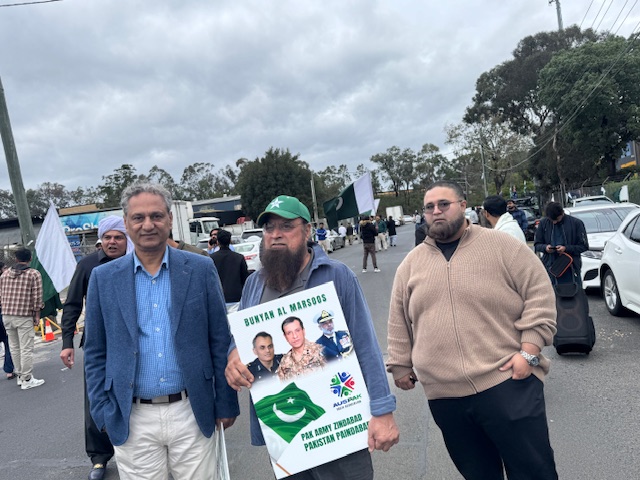 A group of men holding a sign

AI-generated content may be incorrect.