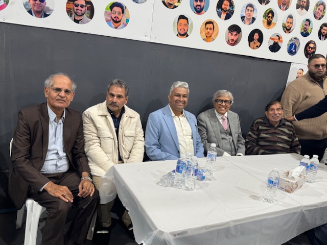 A group of men sitting at a table

AI-generated content may be incorrect.