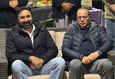 A group of men sitting on a couch

AI-generated content may be incorrect.