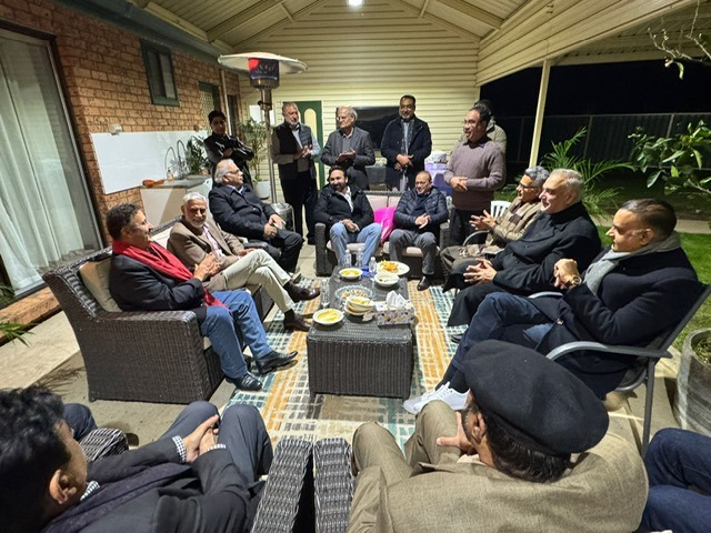 A group of men sitting around a table

AI-generated content may be incorrect.